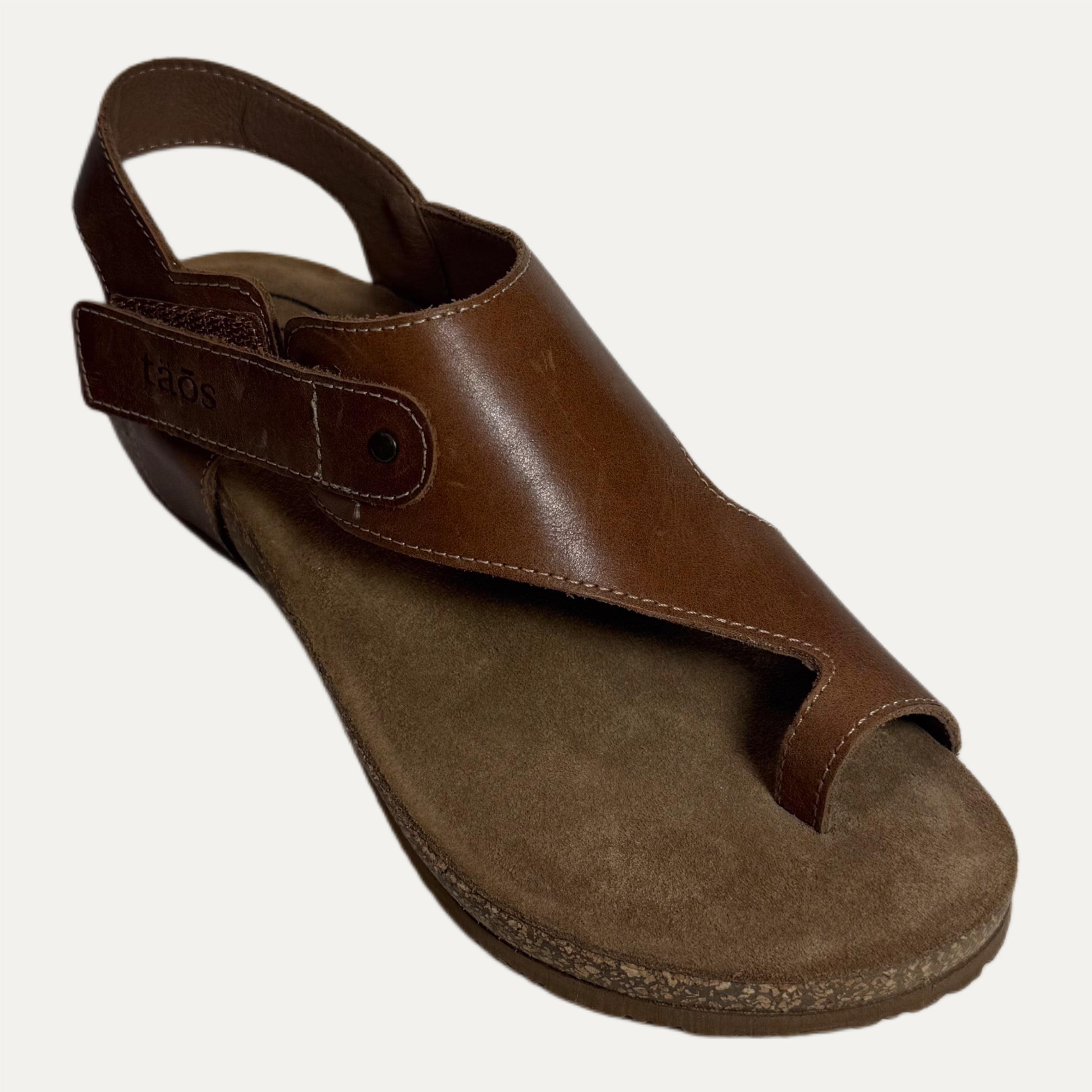 Brown sandal with open toe cork sole on a white background