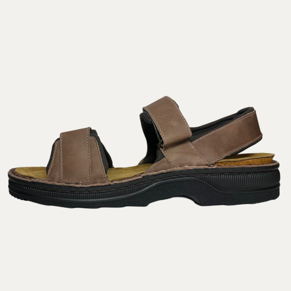Brown sandal with black sole on a white background
