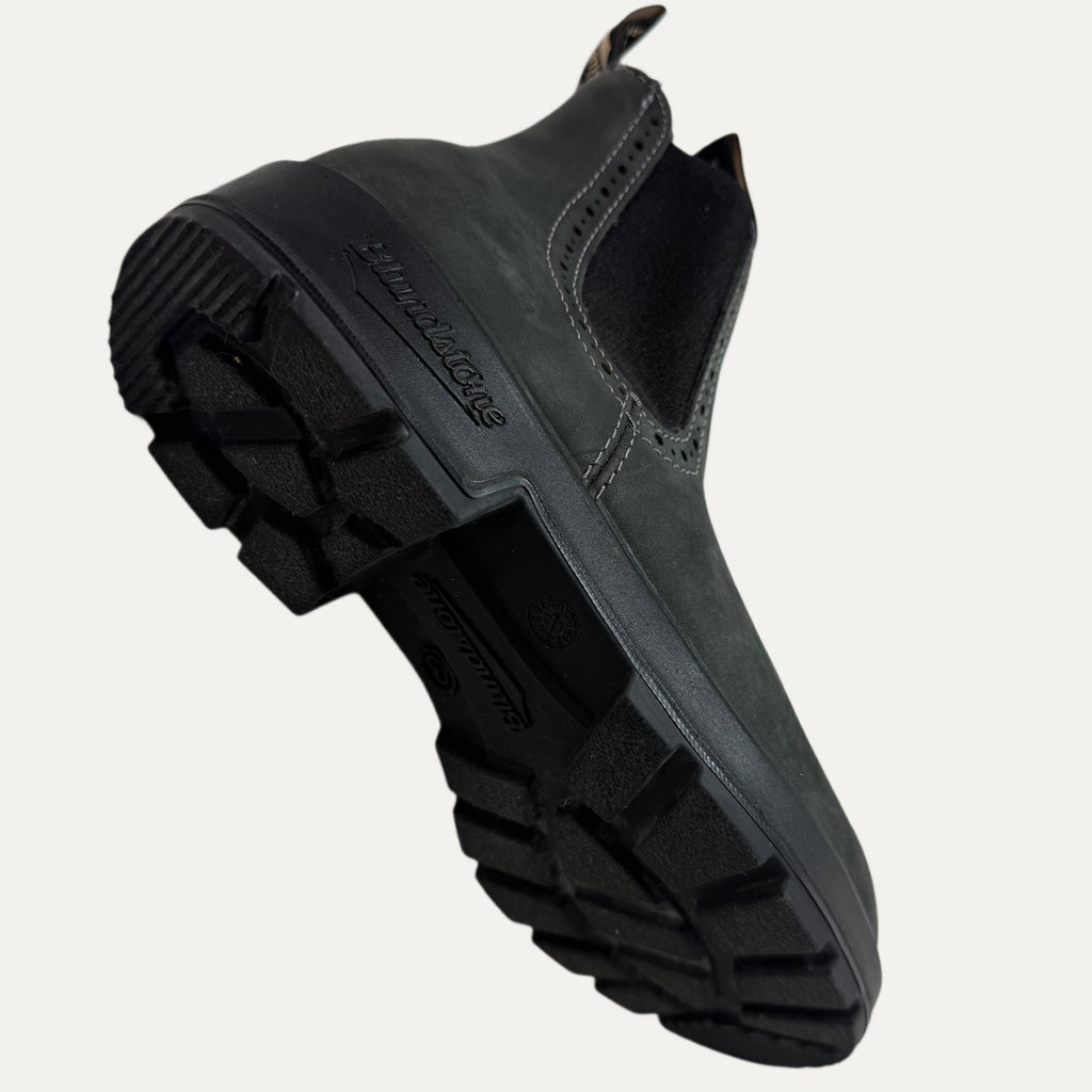 Black slip-on shoe with a thick sole on a white background