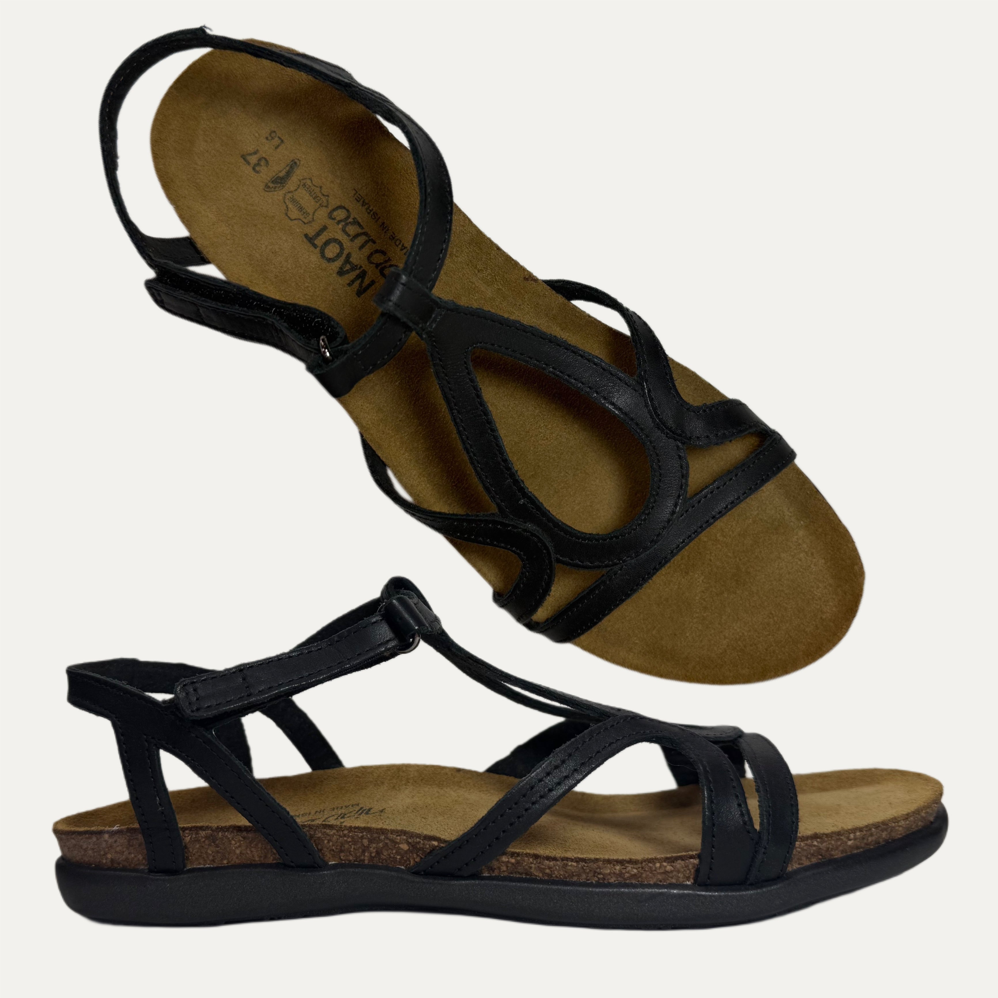 Pair of black strappy sandals on a white background