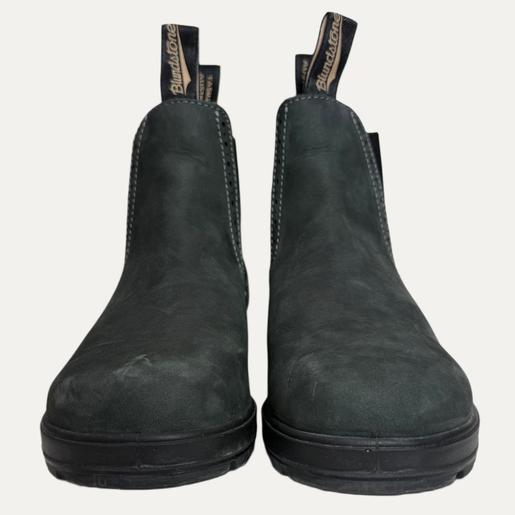 Pair of dark green leather boots with brand name on a white background