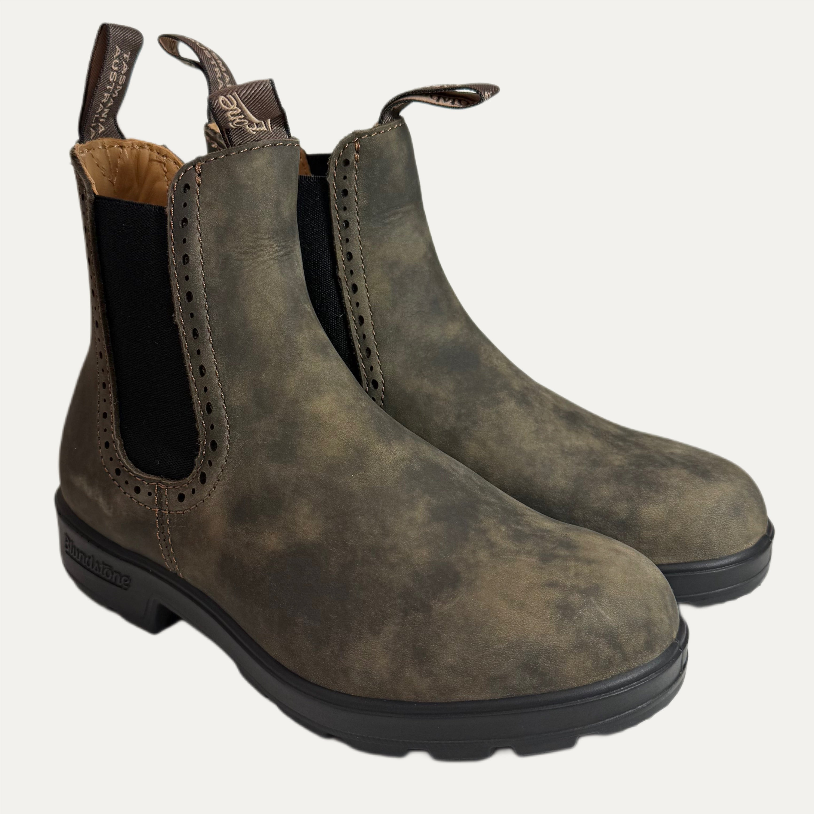 Pair of brown leather boots on a white background