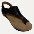 Black sandal with a brown cork sole on a white background