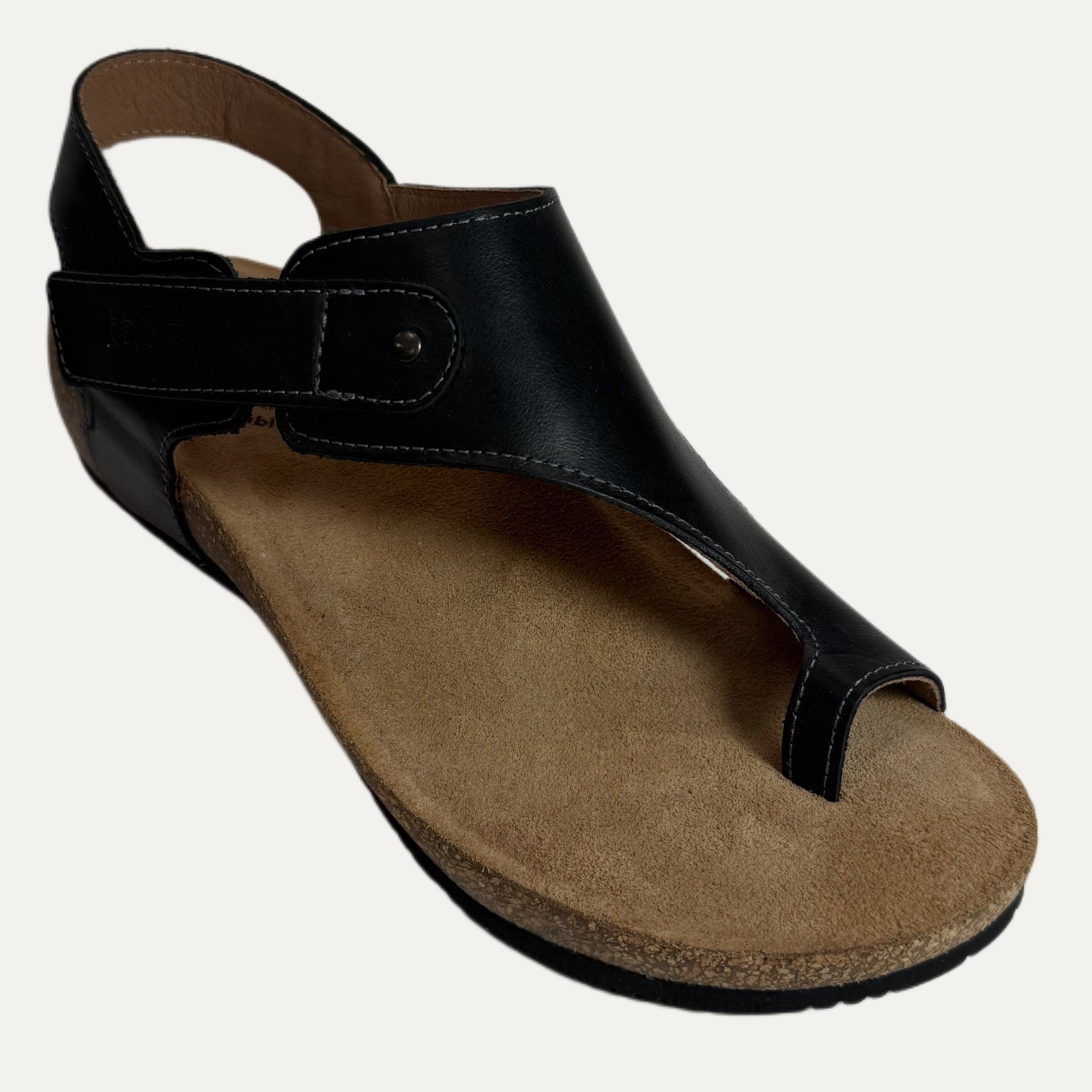 Black sandal with a brown cork sole on a white background