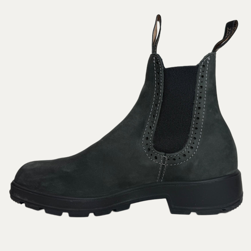 Black Chelsea boot on a light gray background