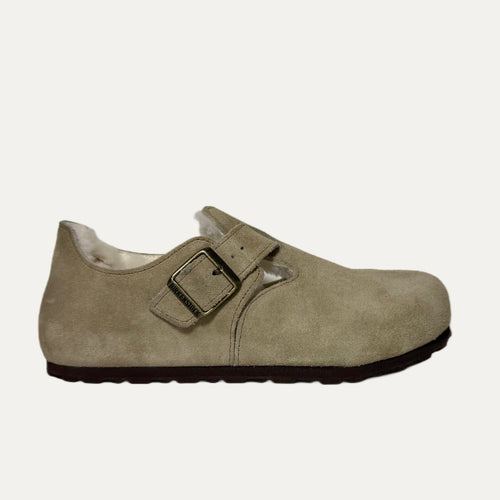 Beige suede shoe with a buckle on a white background