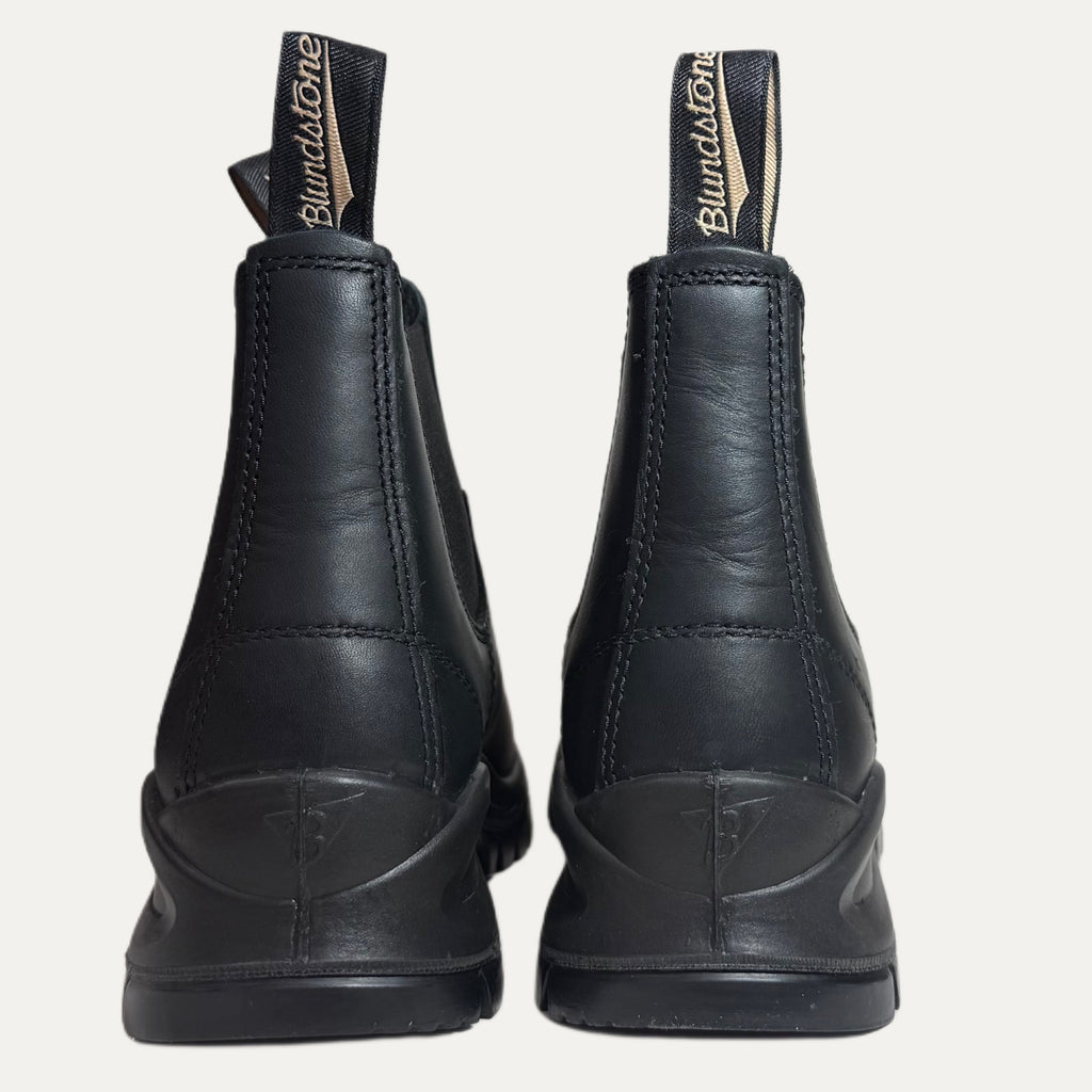 Black lugged boots with Blundstone branding on a white background