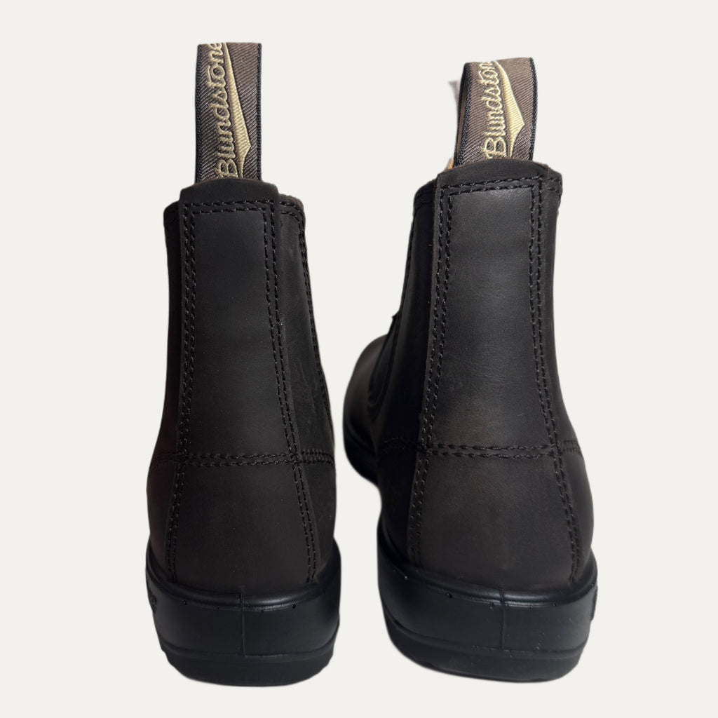 Black leather boots with Blundstone branding on a white background