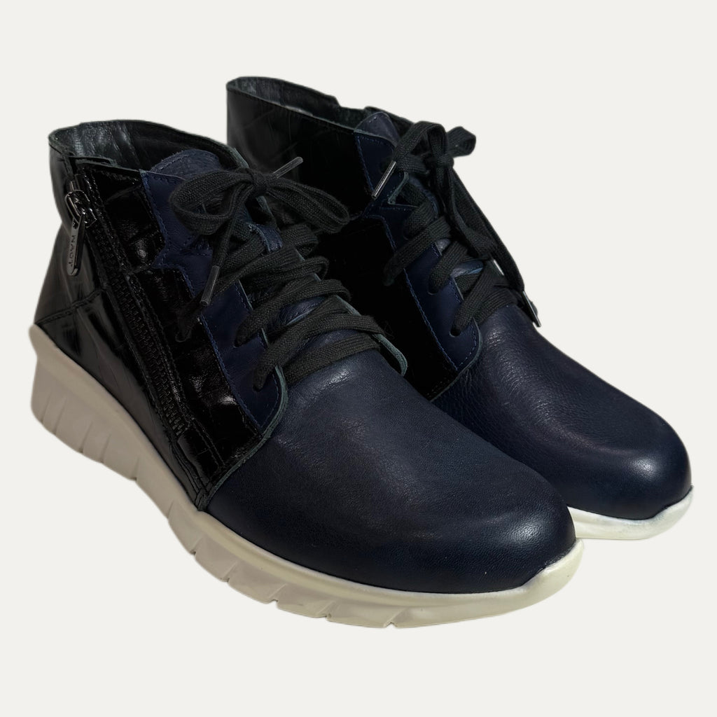 Pair of blue leather boots with white soles on a background