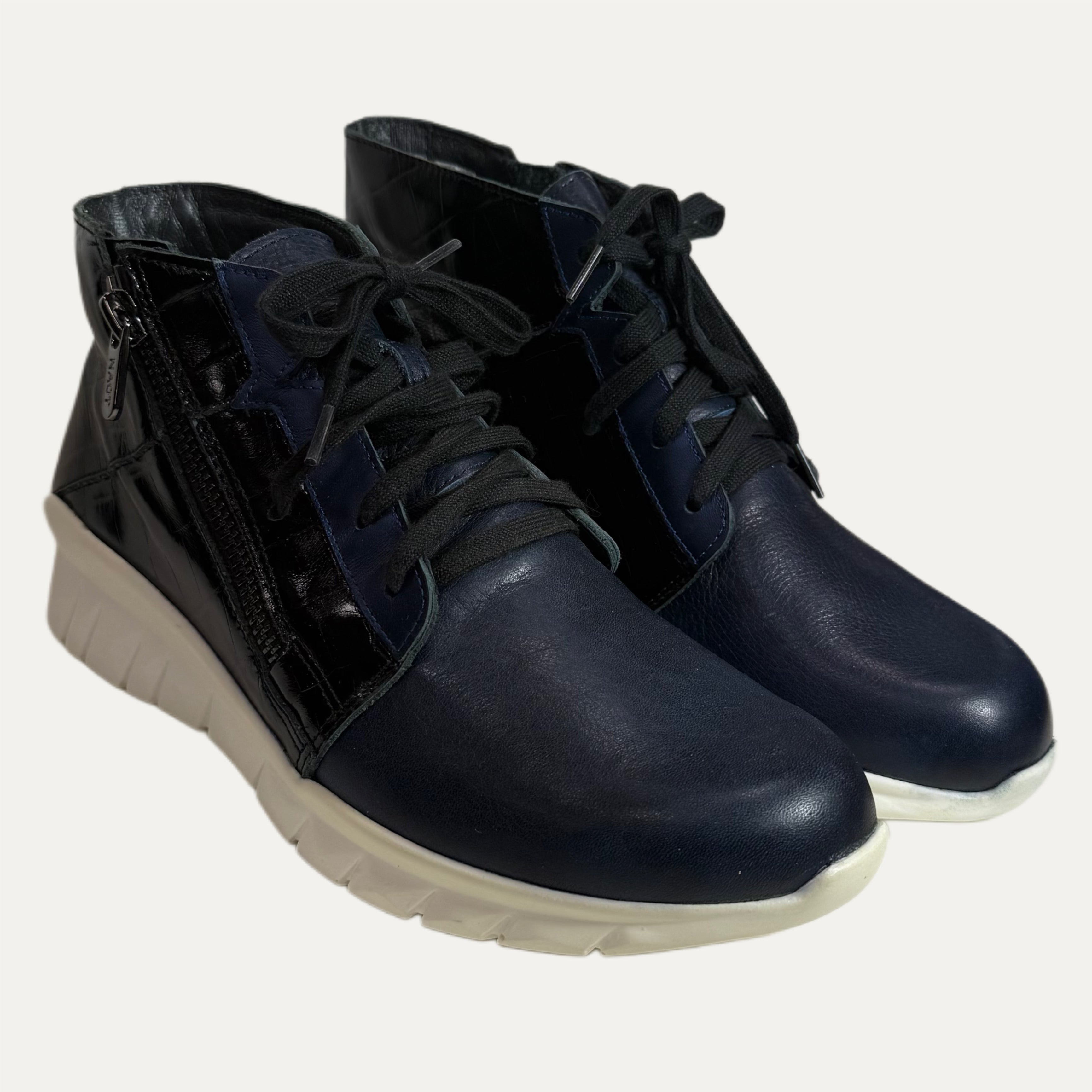 Pair of blue leather boots with white soles on a background
