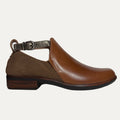 two tone Brown cutout bootie shoe with a strap and buckle on a white background