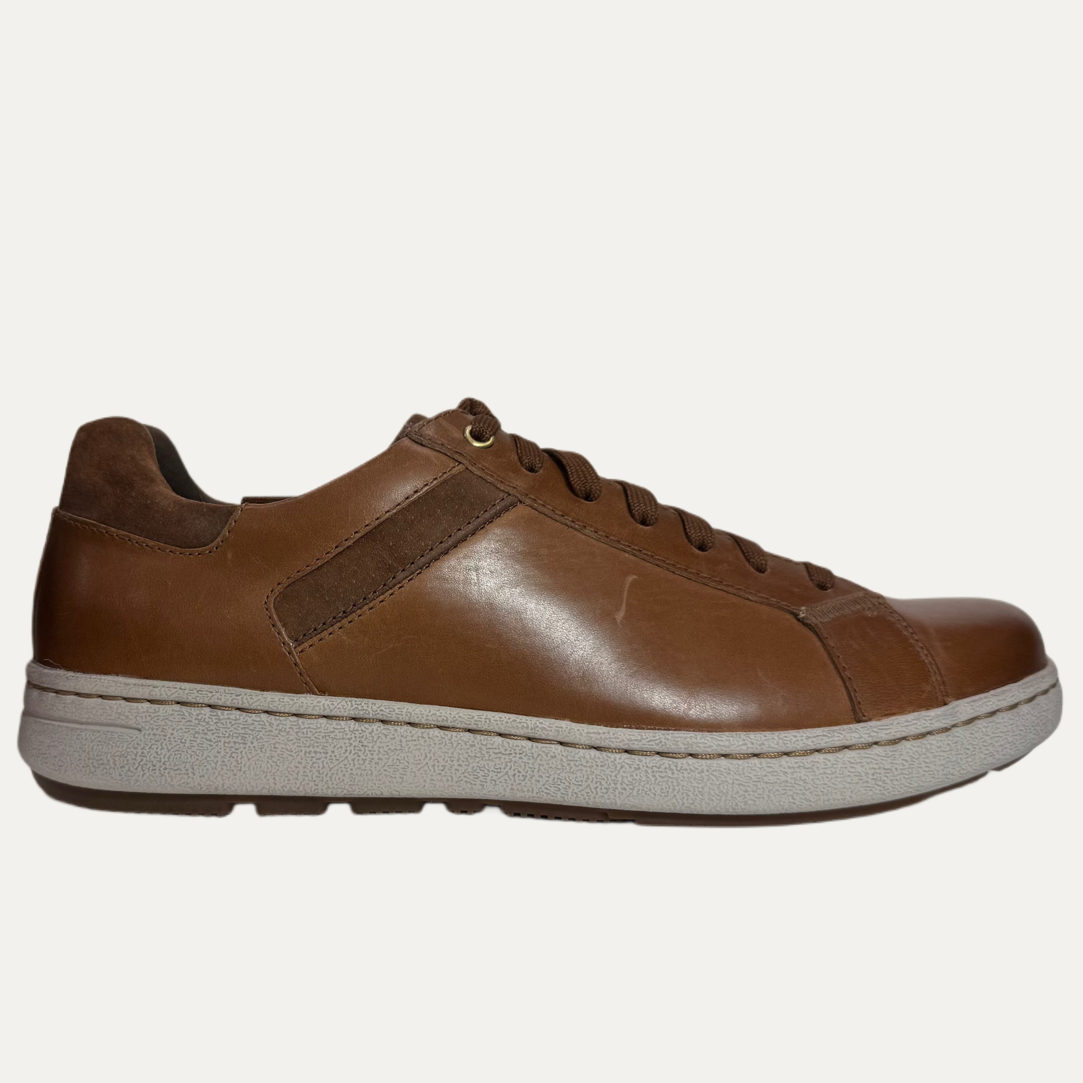 Brown leather lace-up with a white sole on a white background