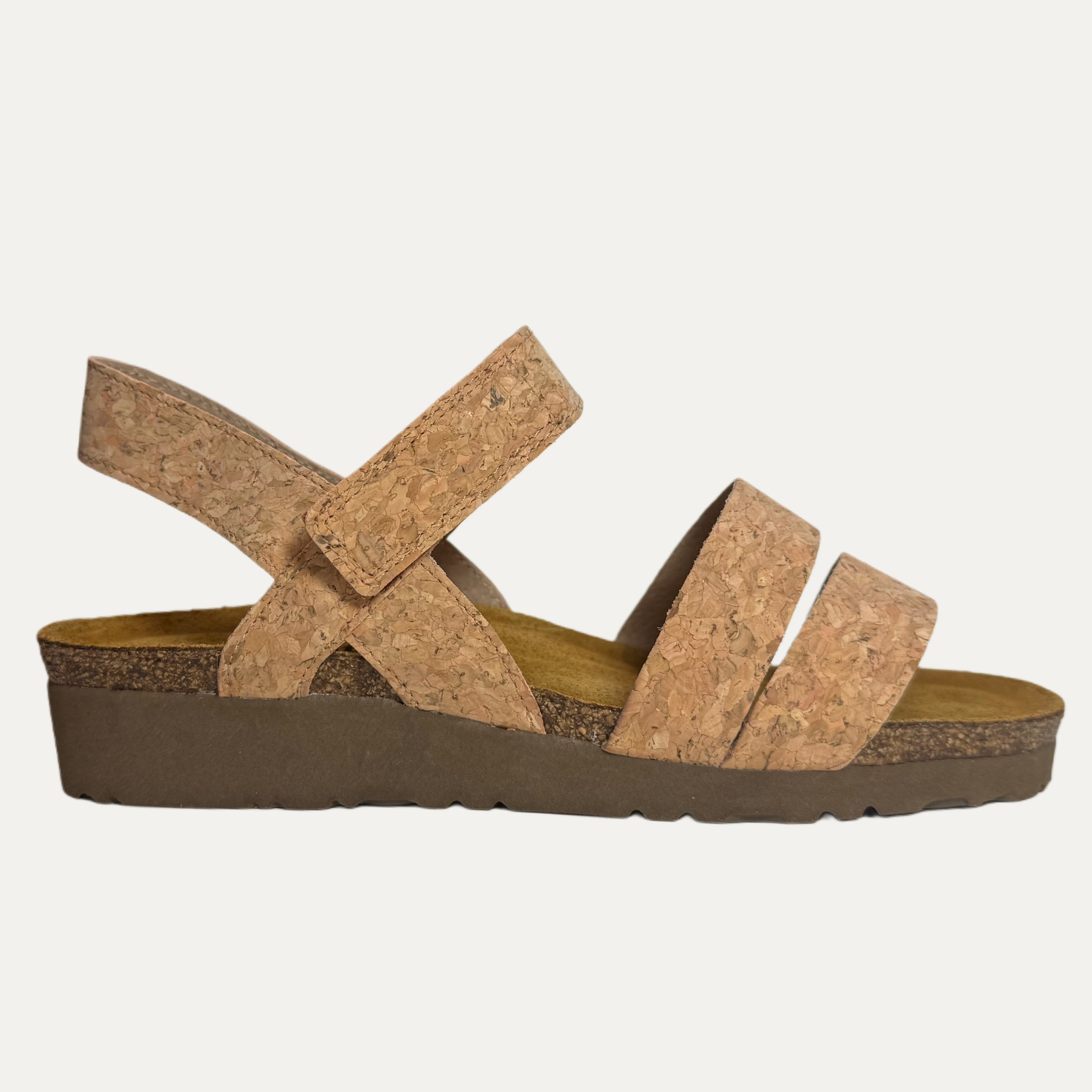 Brown cork sandal with a cork insole and brown sole on a light gray background