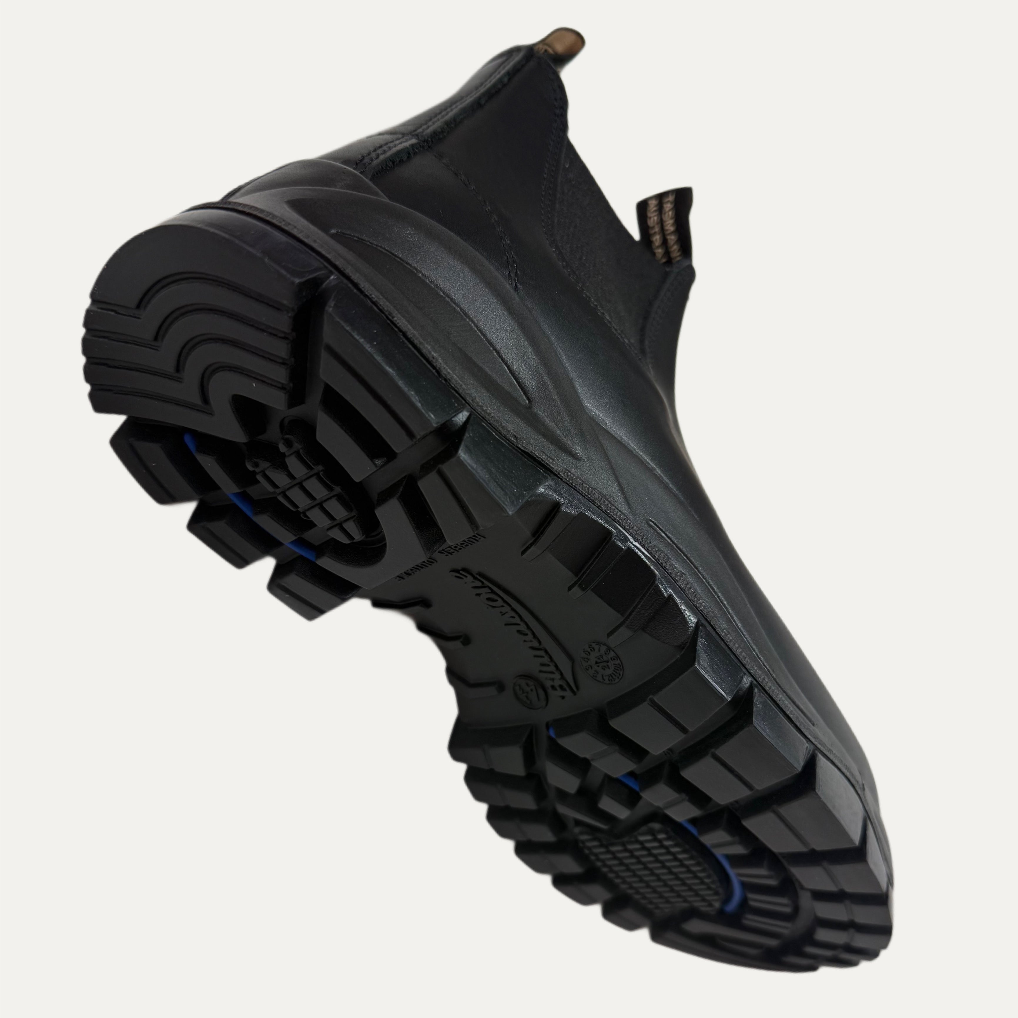 Black lugged boot with a detailed sole on a white background