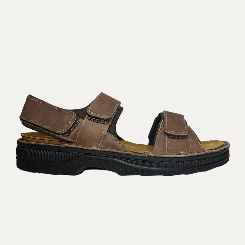 Brown sandal with black sole on a white background