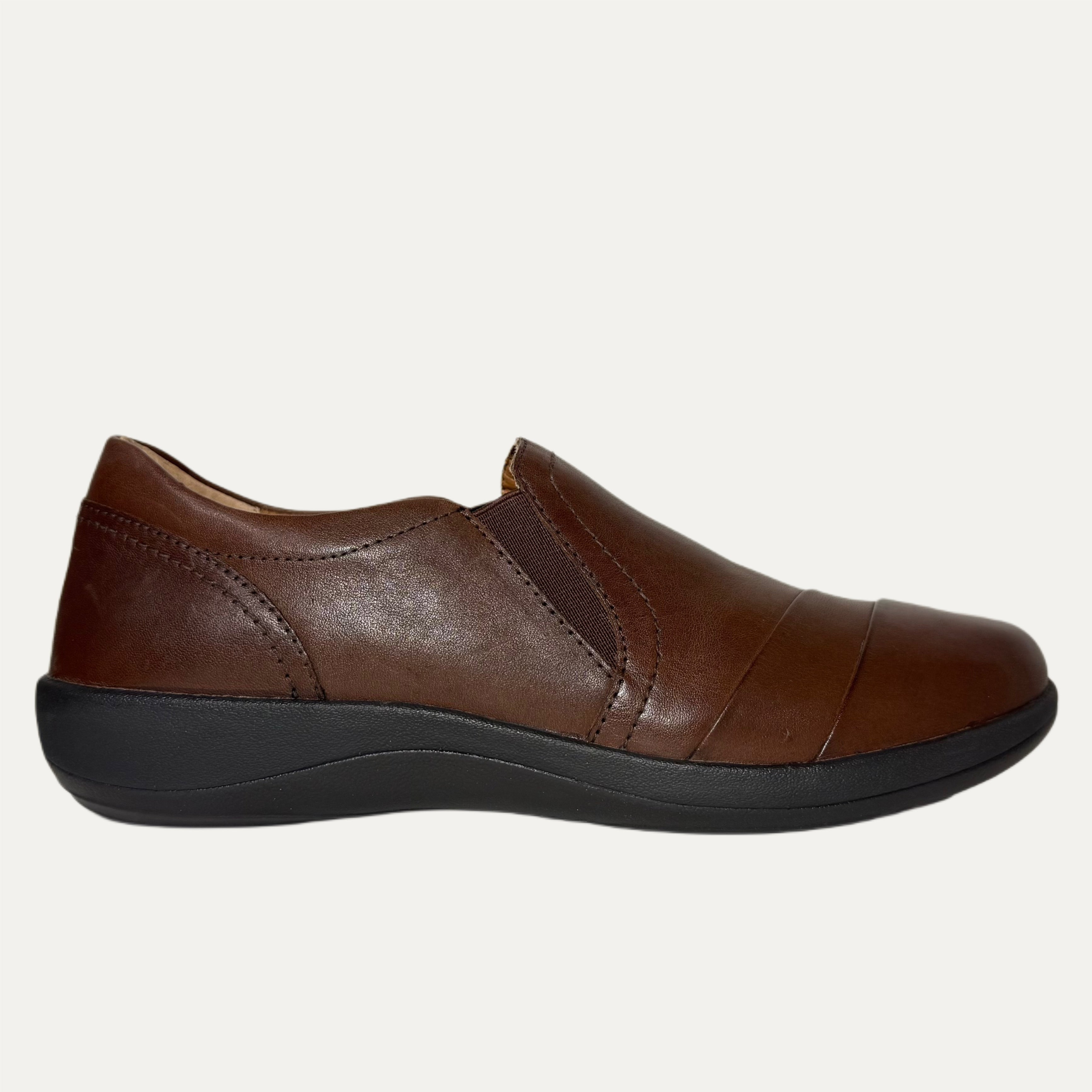 Brown leather slip-on shoe on a white background
