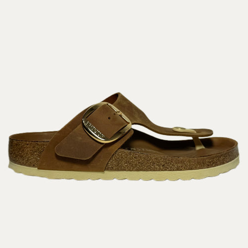 Brown sandal with a gold buckle on a white background