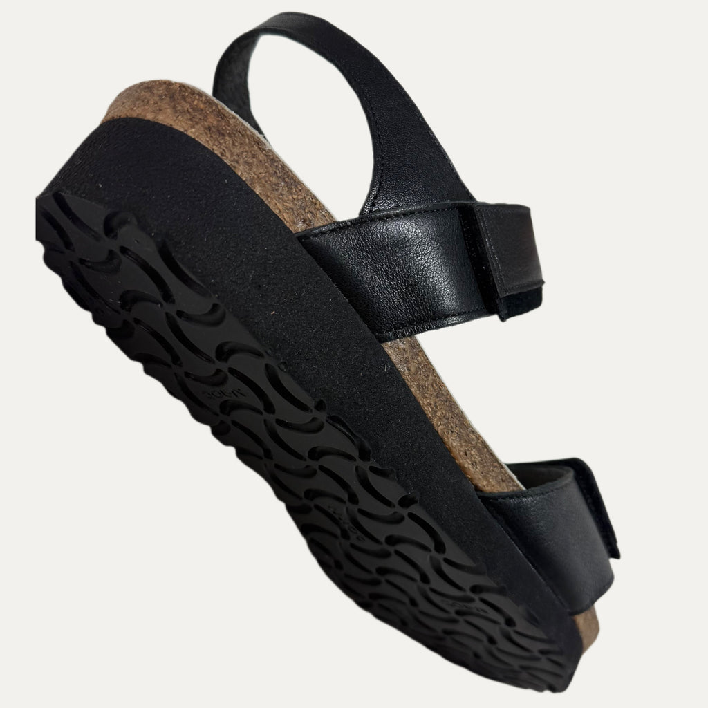 Black sandal with a cork sole on a white background
