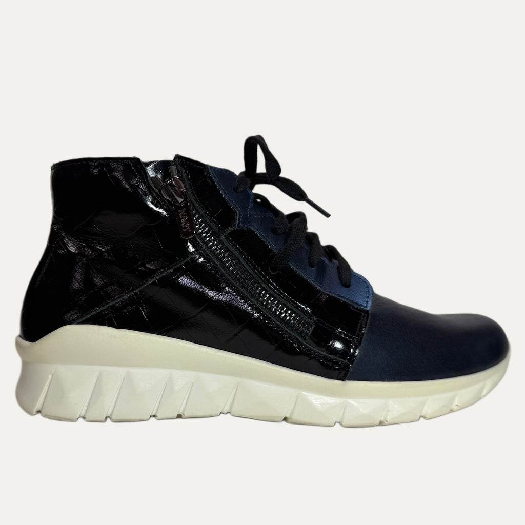 Black high-top sneaker with white sole on a white background