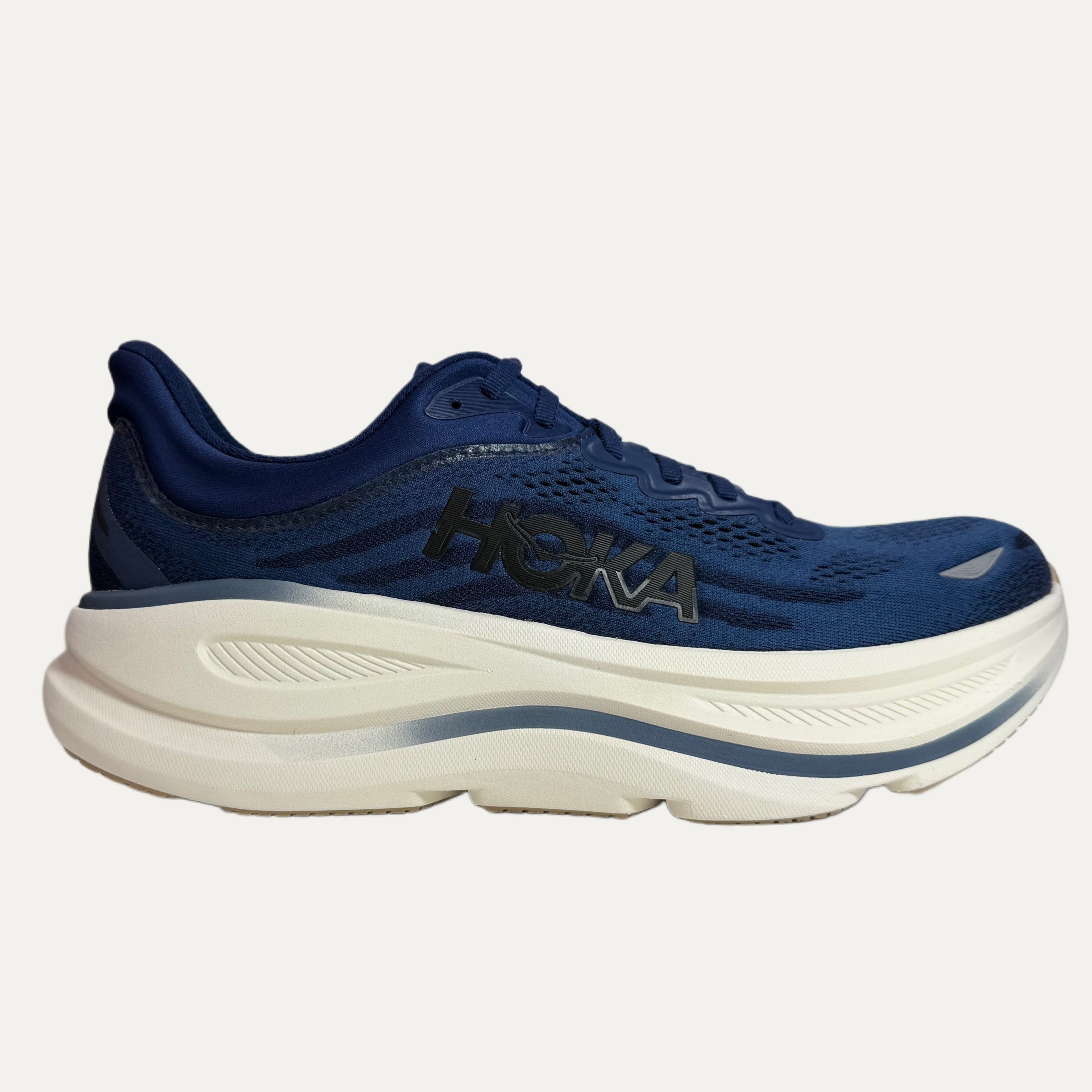 Blue running shoe with white sole on a light gray background