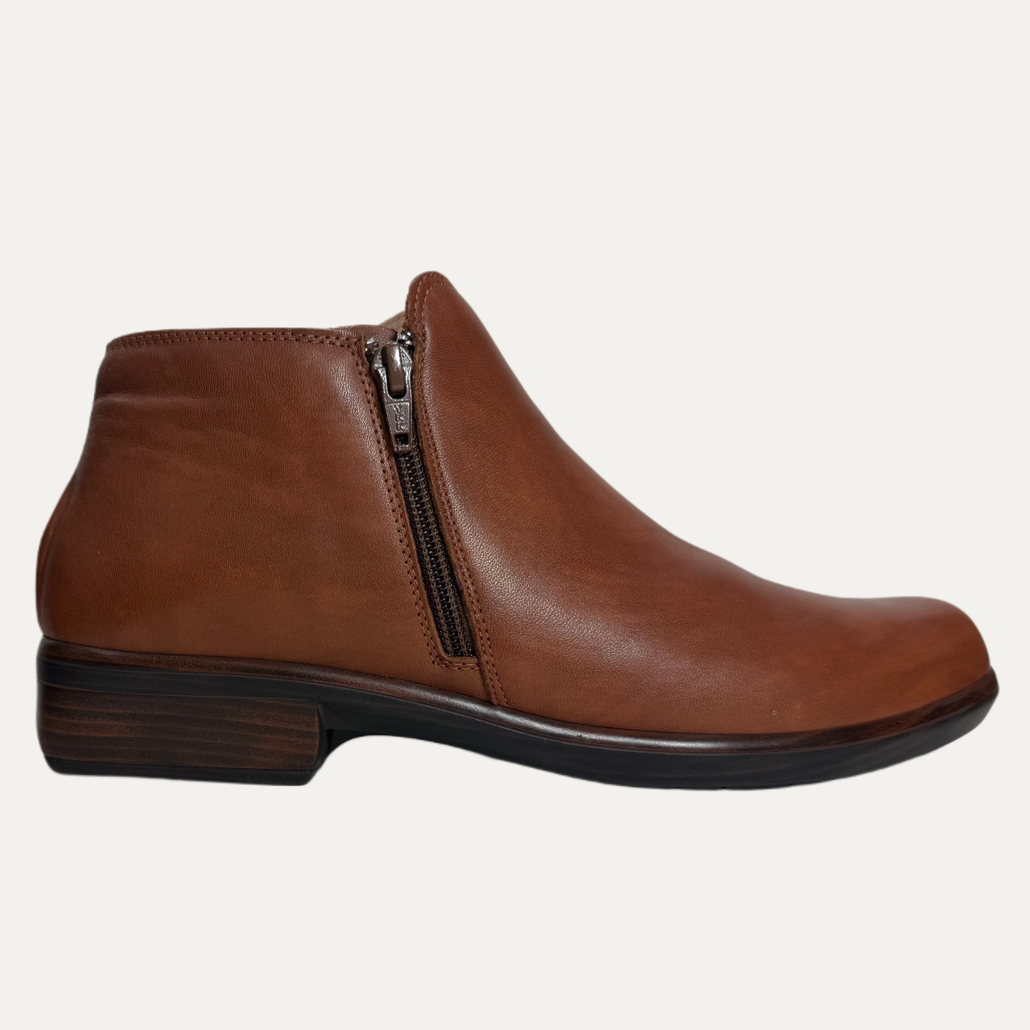 Brown leather ankle boot with a zipper on a white background