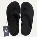 Black flip flops with a brand tag on a white background