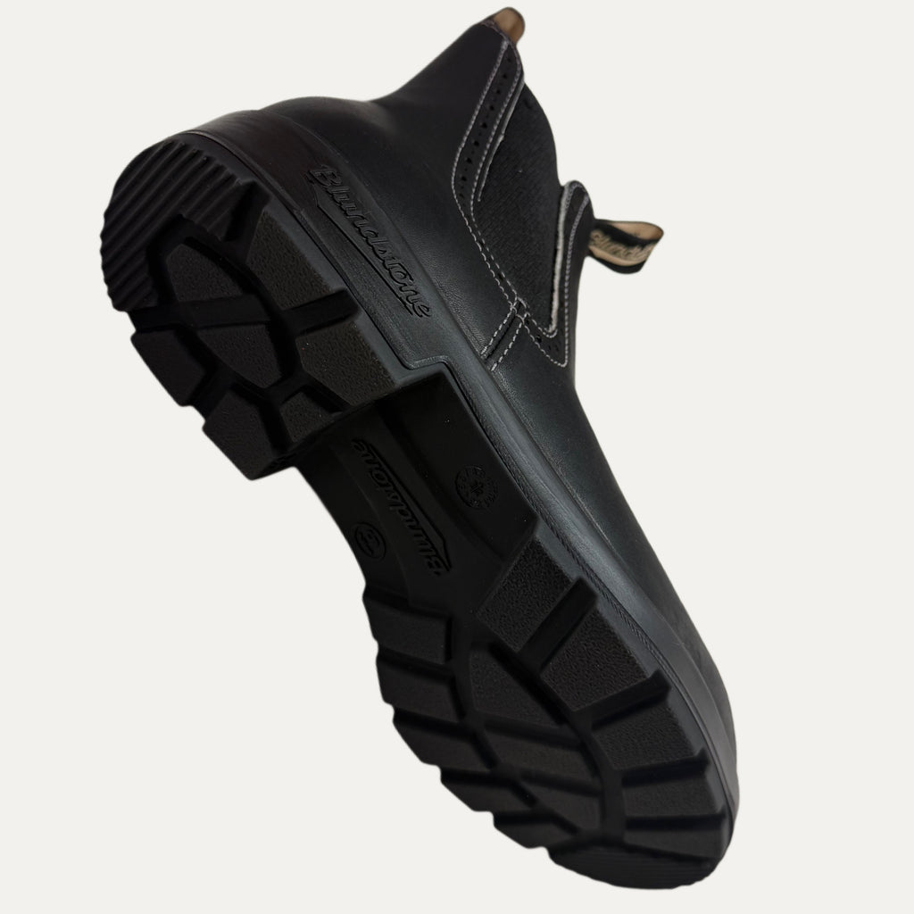Black boot with angle showing sole on a white background