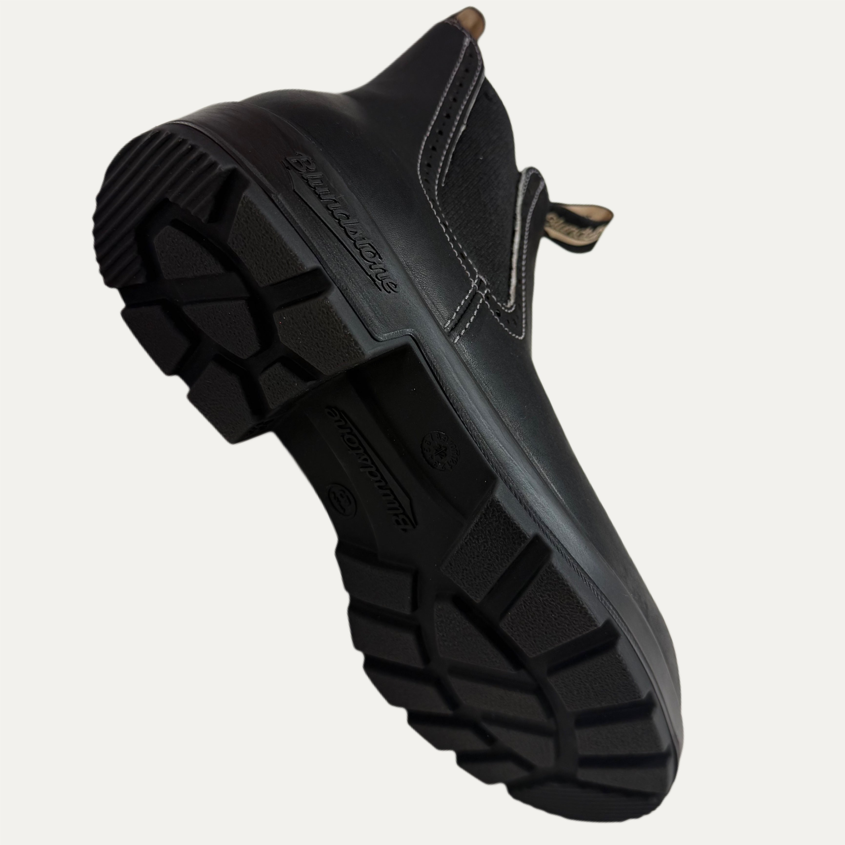 Black boot with angle showing sole on a white background