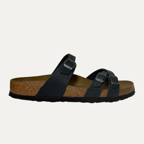 Black sandal with cork sole on a light gray background