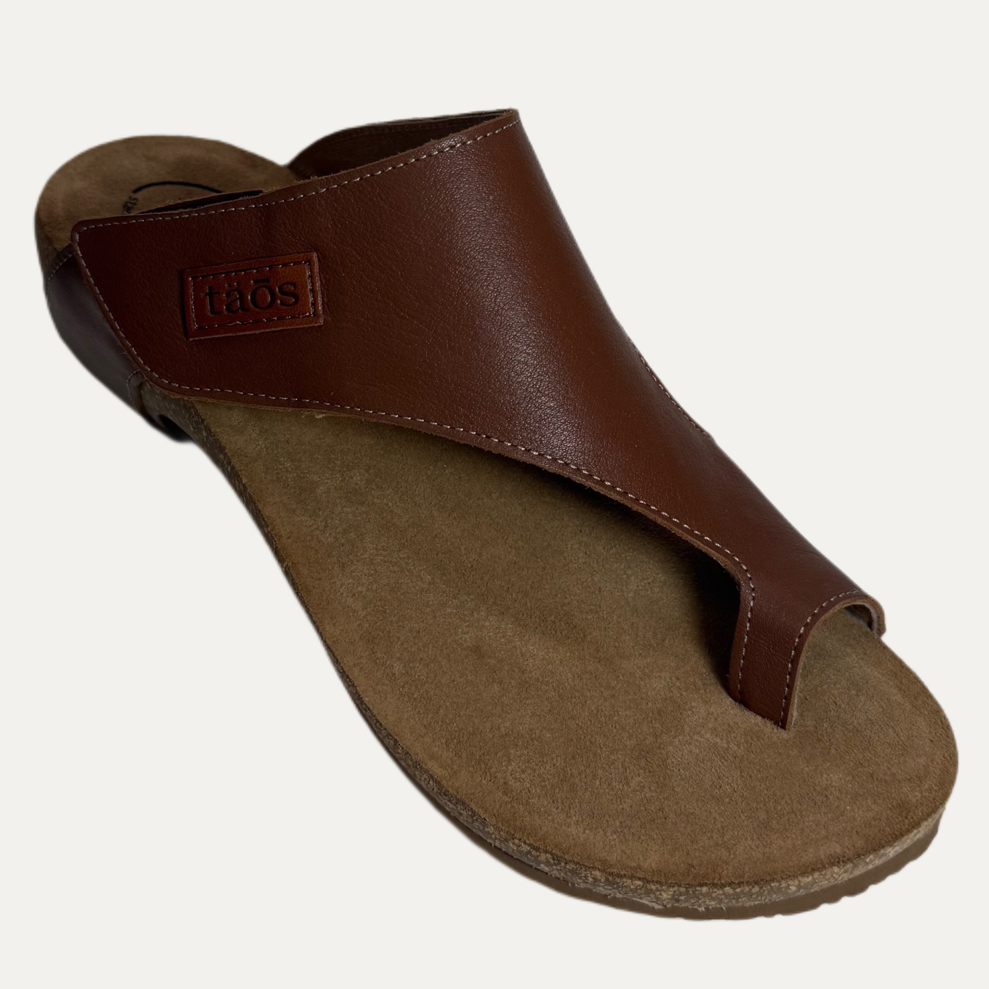 Brown sandal with a cork sole on a white background