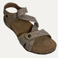 Brown sandal with woven straps on a white background