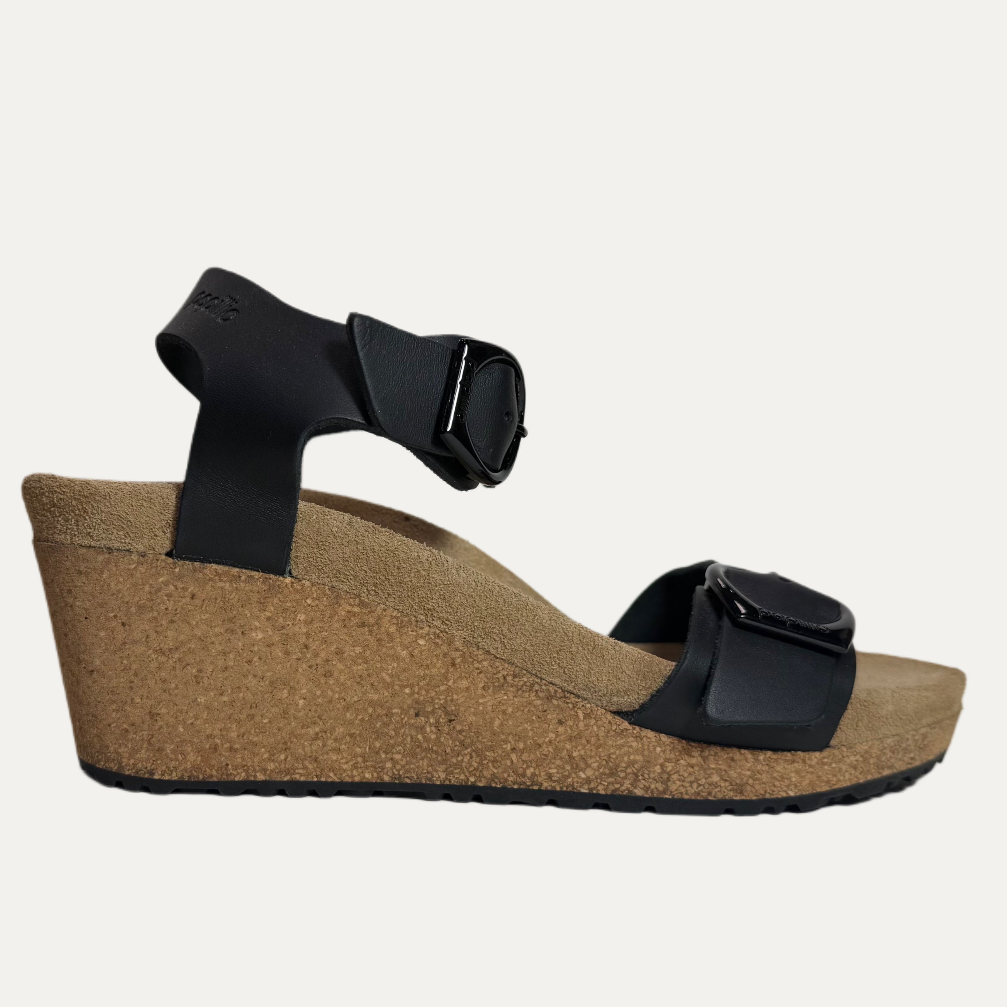 Black wedge sandal with cork sole on a white background
