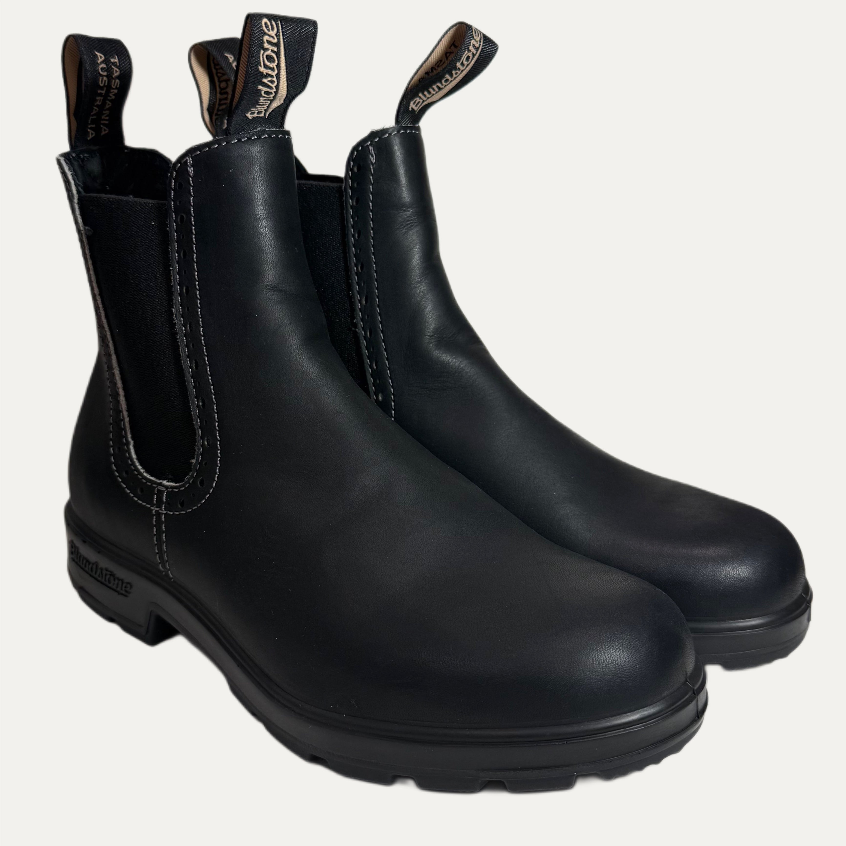 Pair of black leather boots on a white background