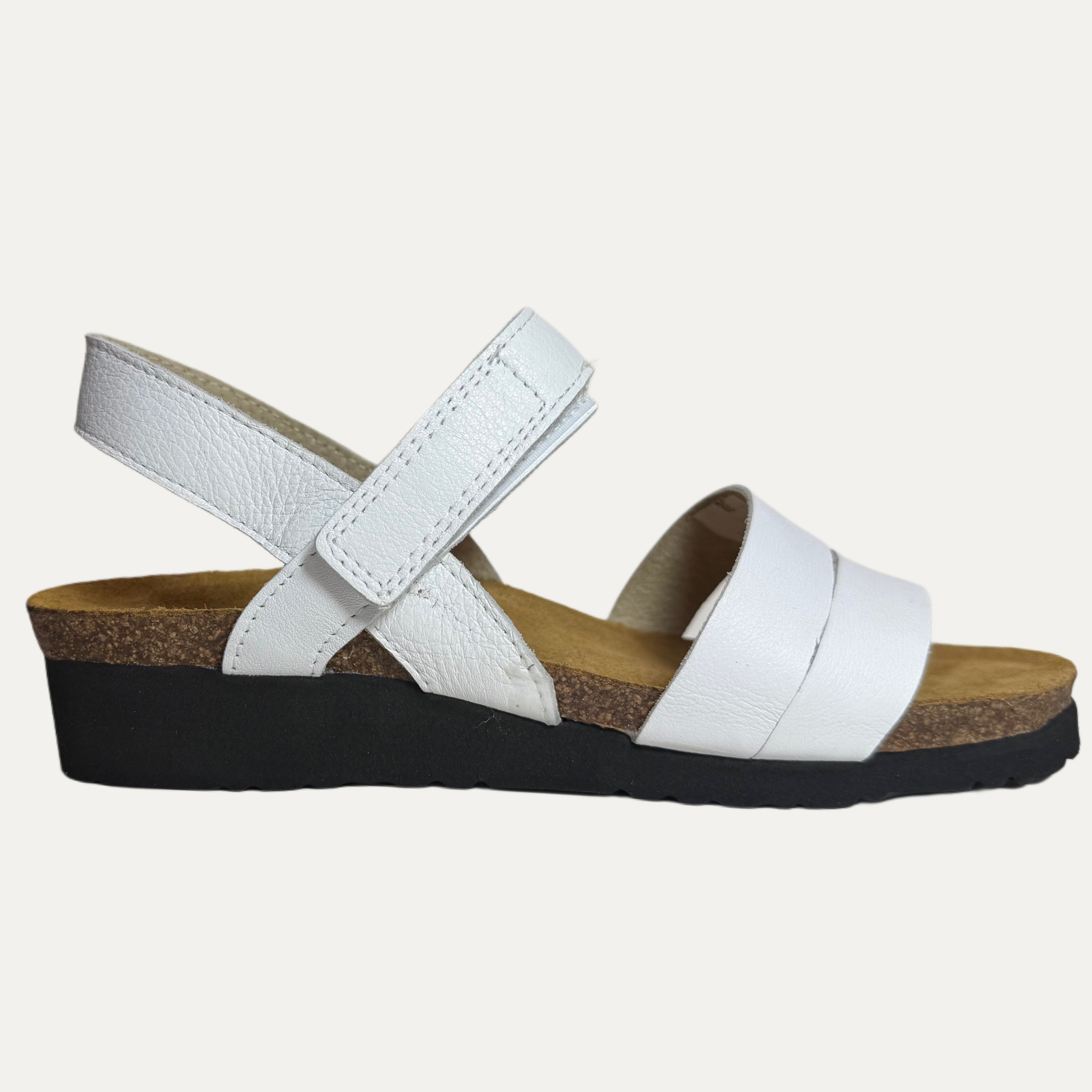 White sandal with a cork and black sole on a white background