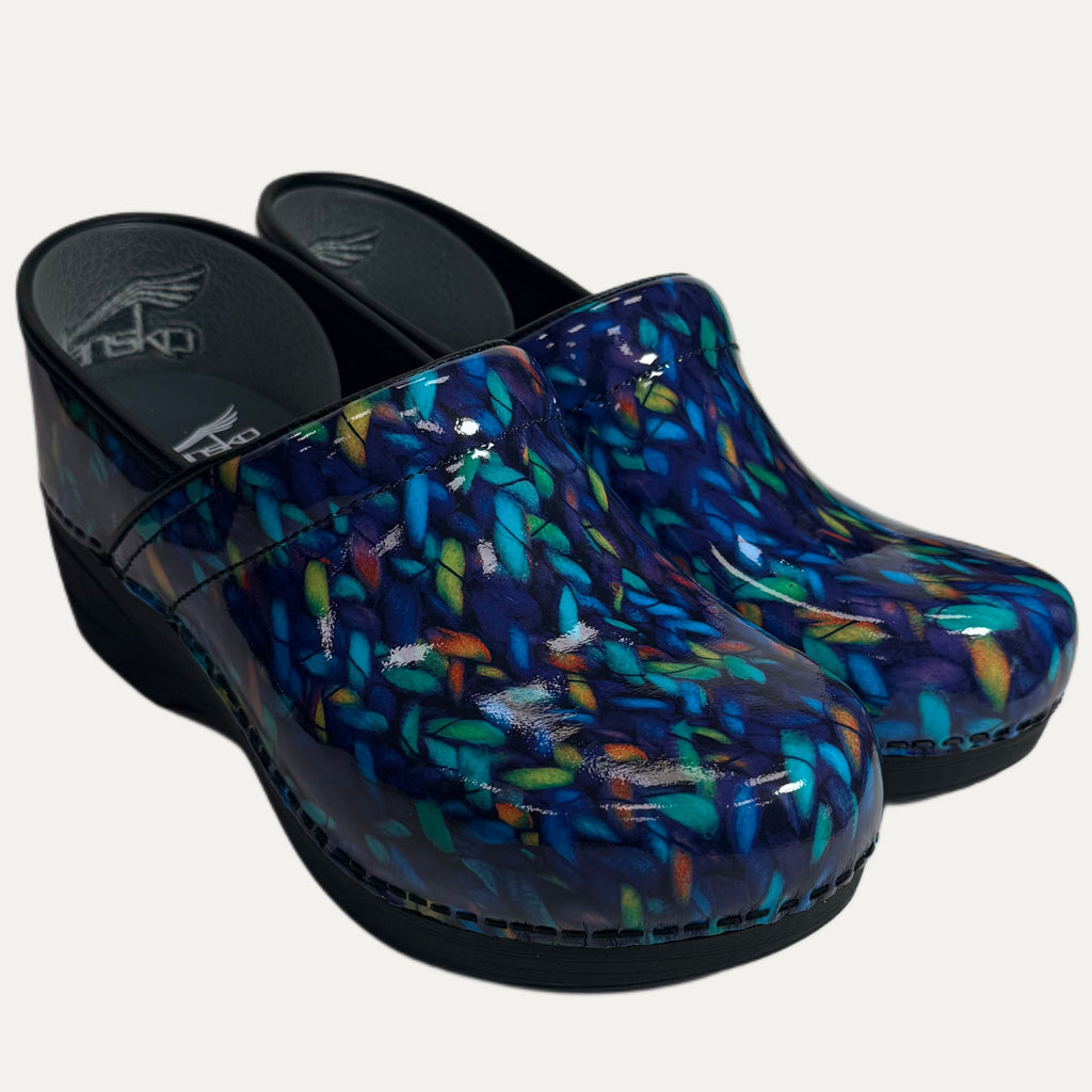 Pair of patent blue clogs with colorful feathered pattern on a white background