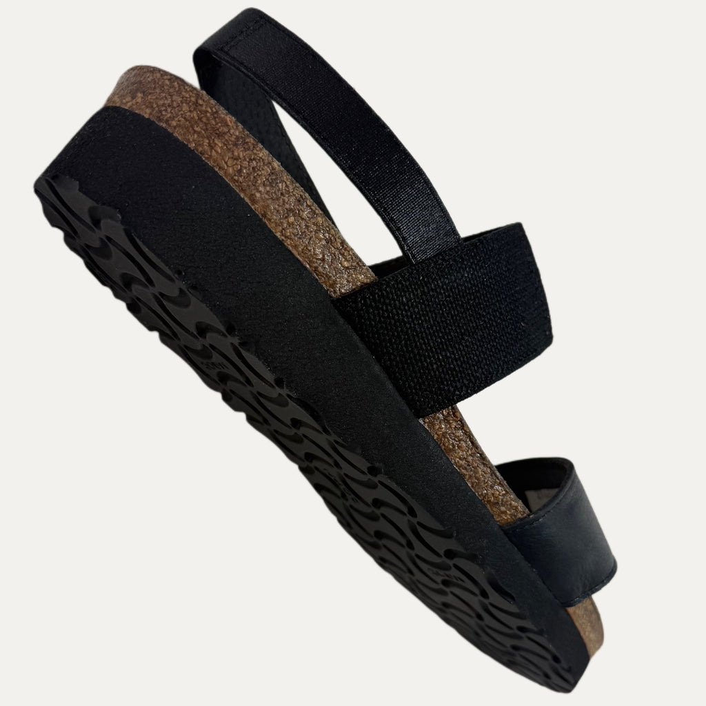 Black sandals with cork sole on a light gray background