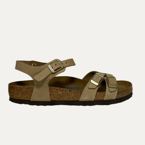 Brown sandal with cork sole on a light gray background