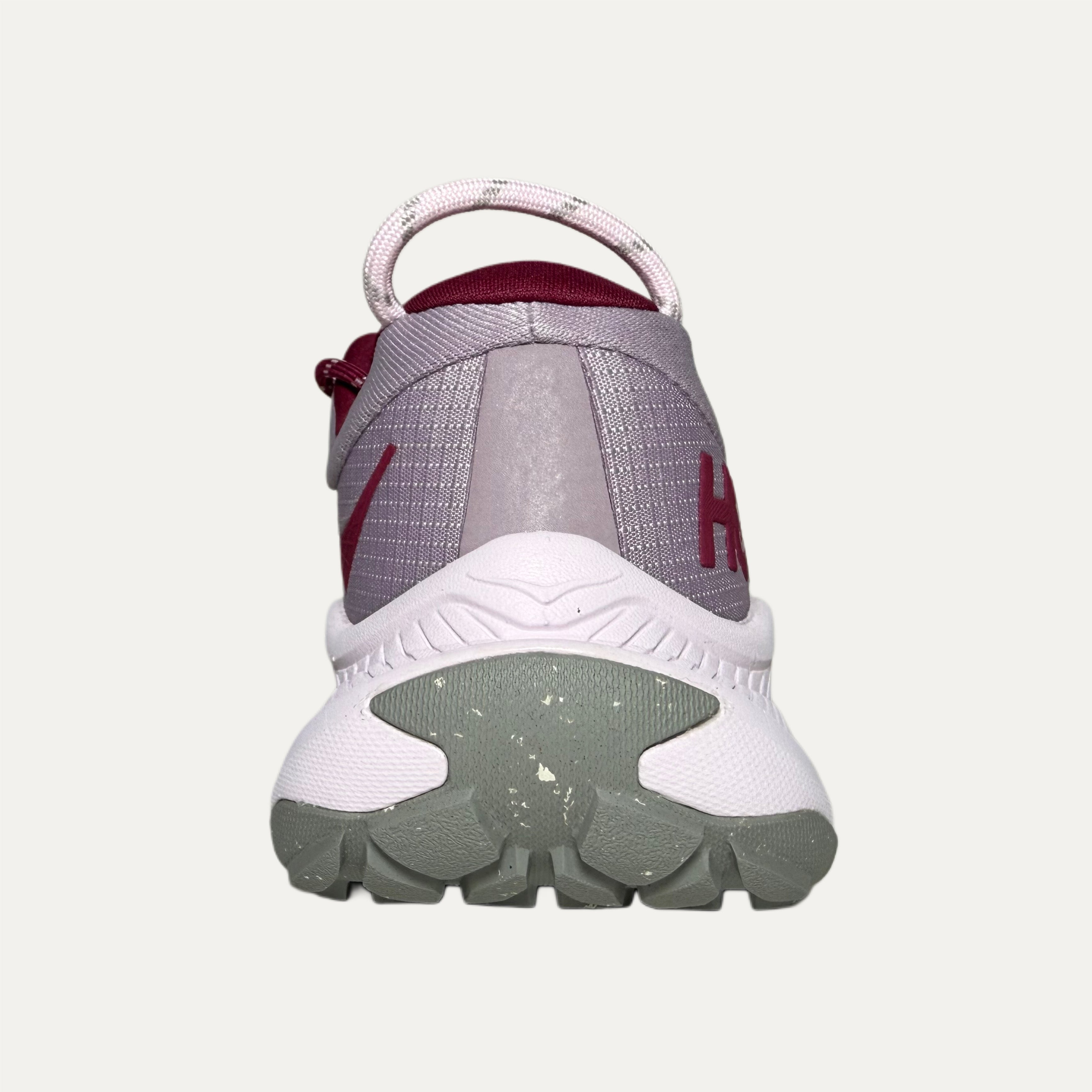 back of Lilac, red and pink athletic HOKA Transport shoe on white background