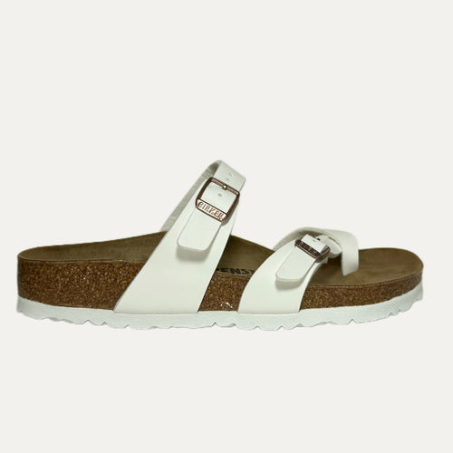 White sandal with cork sole on a light gray background