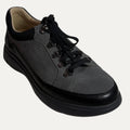 Gray shoe with black laces on a white background