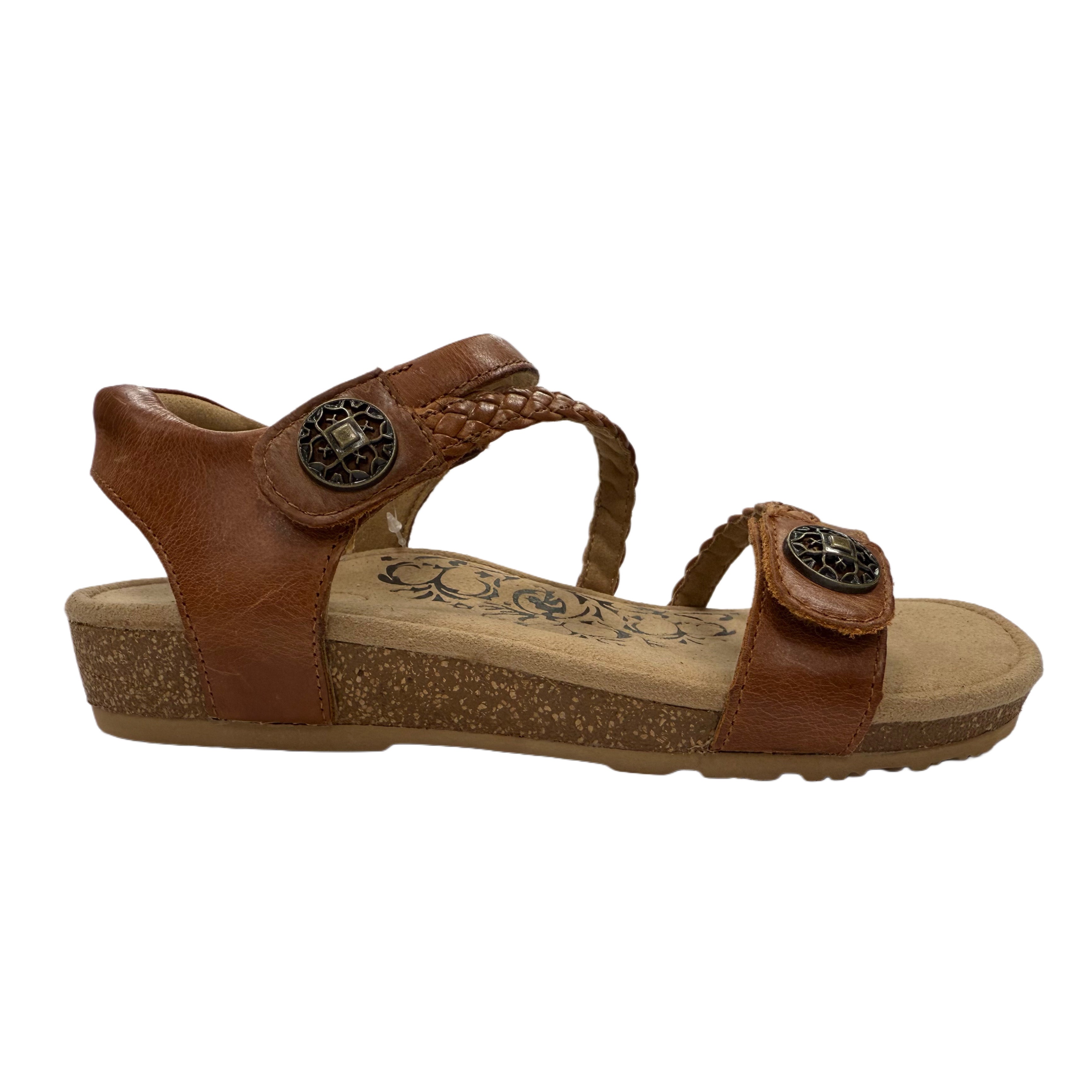 cognac brown sandal with decorative straps on a white background