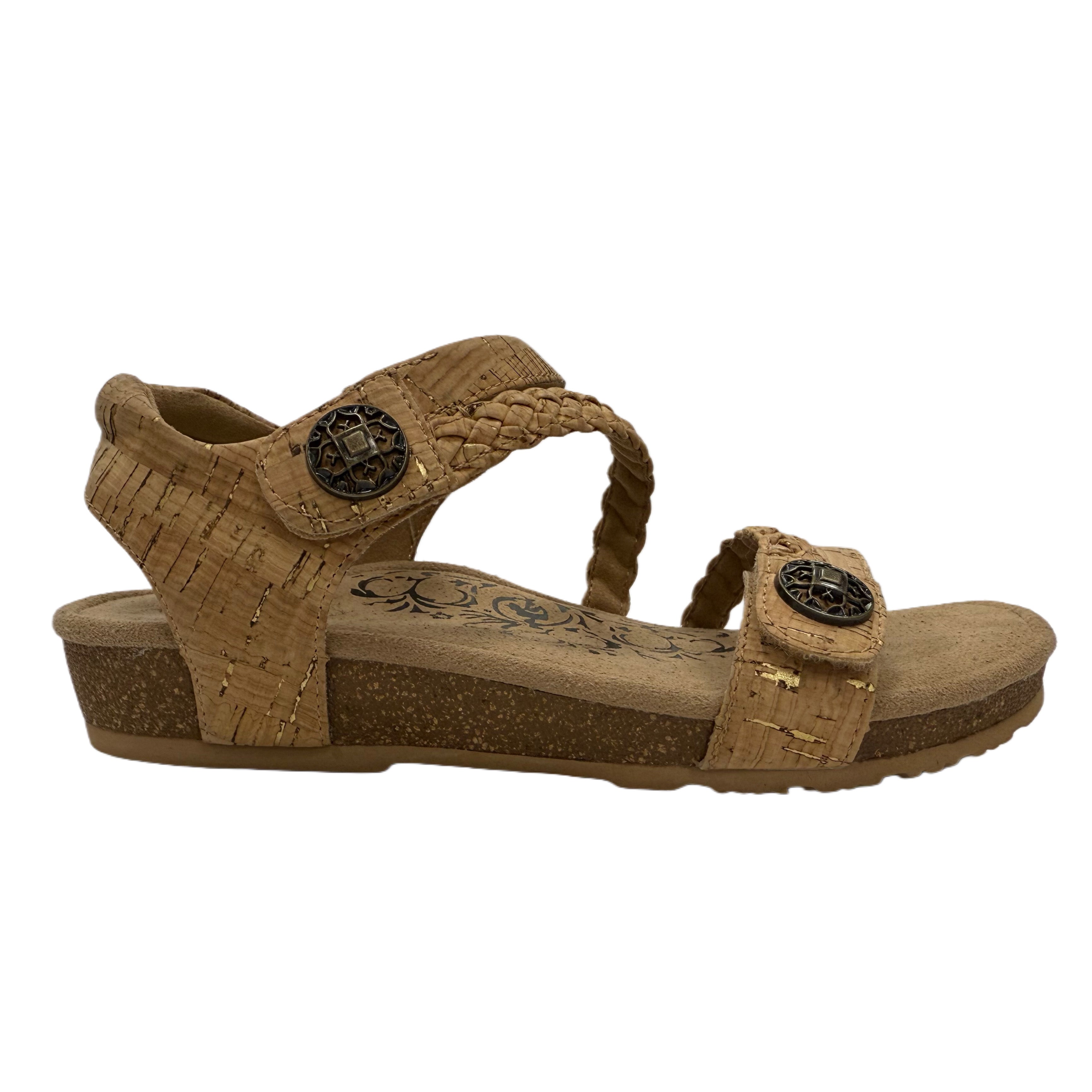 Brown cork sandal with decorative straps on a white background