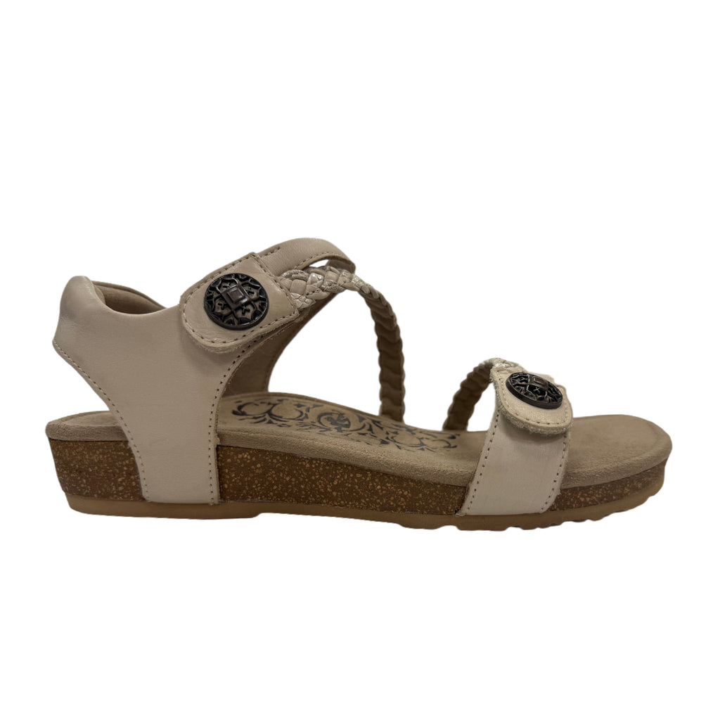 ivory cream sandal with decorative straps on a white background