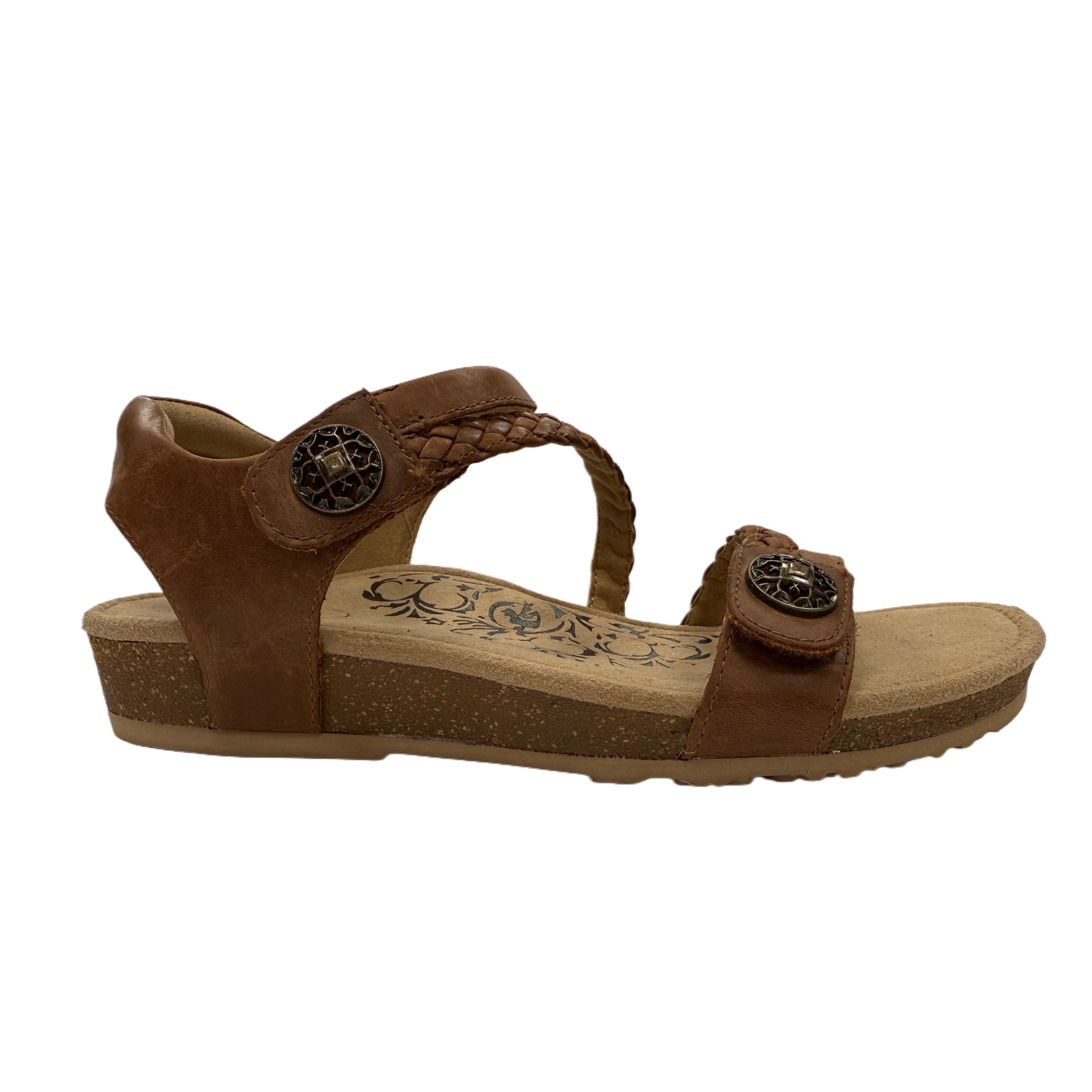 Brown walnut sandal with decorative straps on a white background